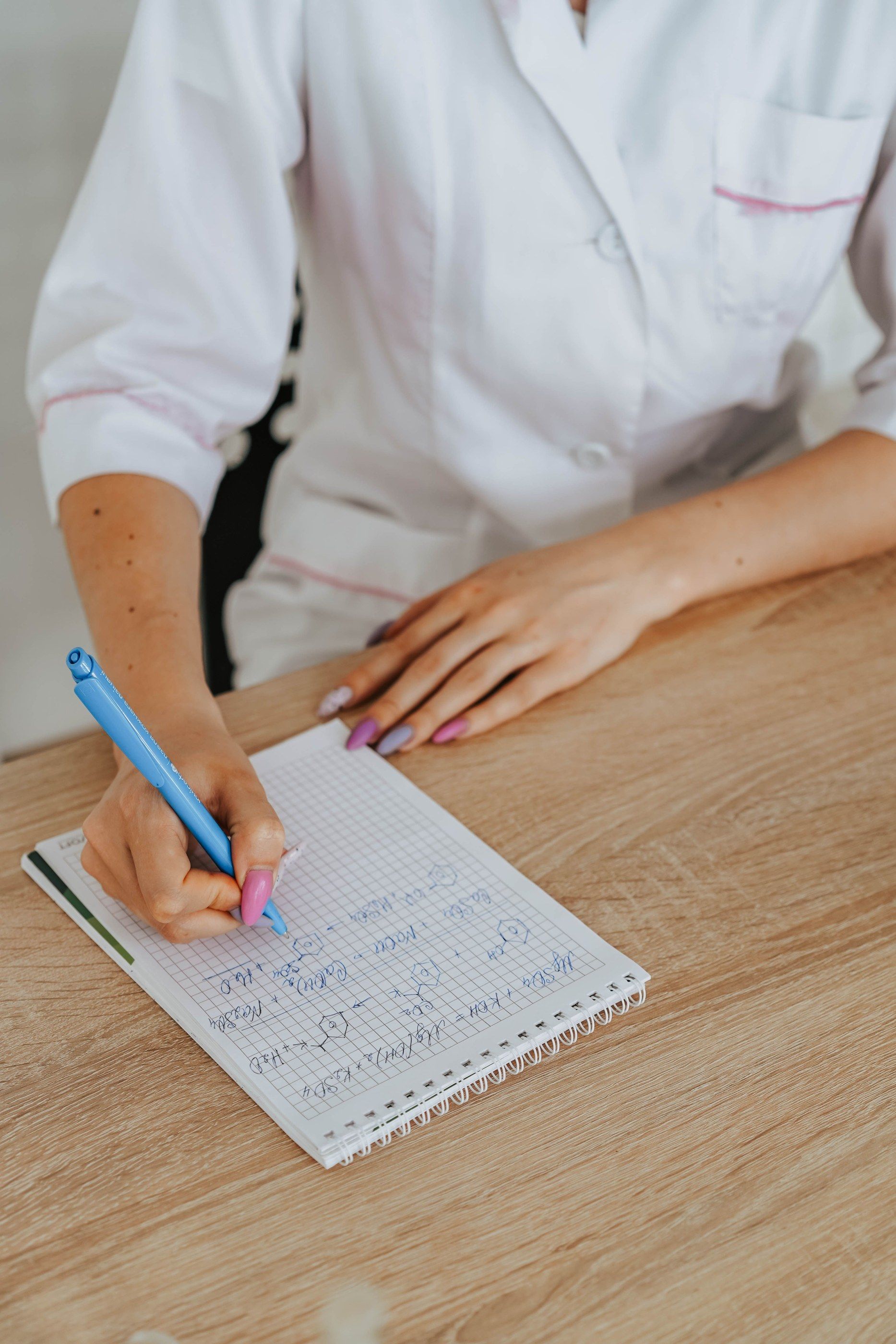 Hand writing in a laboratory notebook